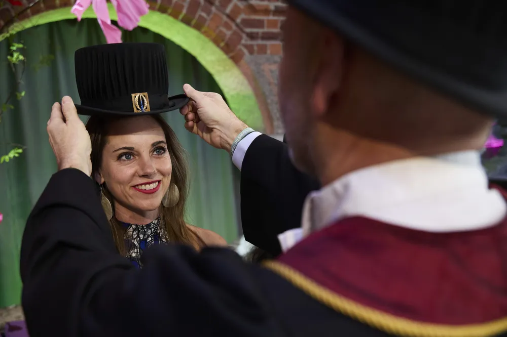 Miriam Hartmann receives her doctoral hat from promoter Bob Harris.