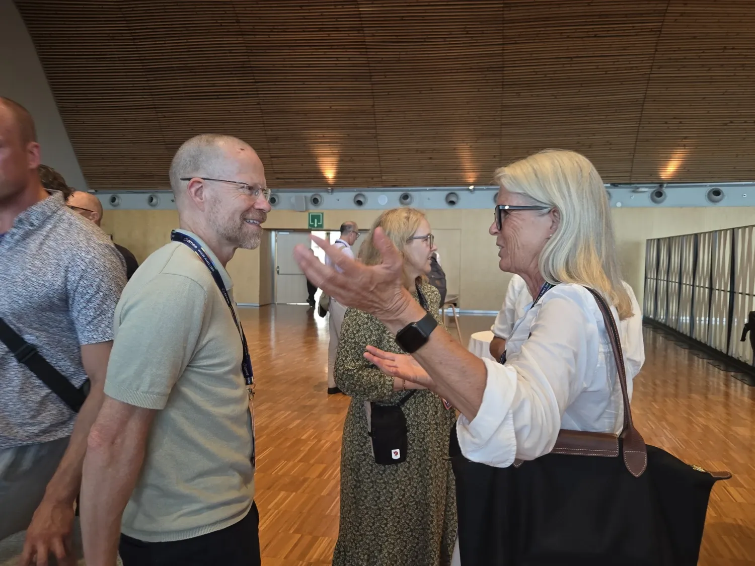 Brian and Helen in profile talking with each other.