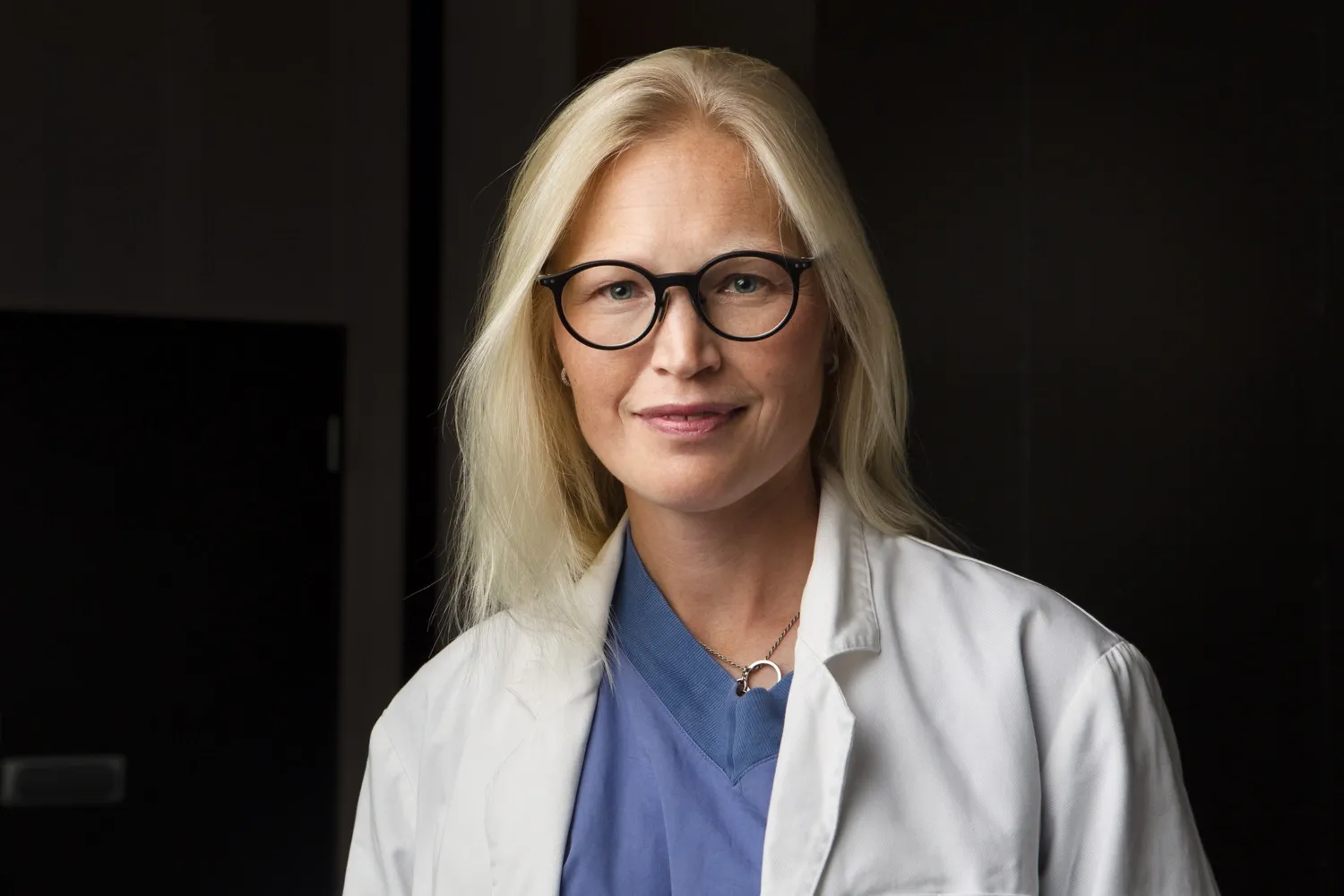 Portrait of woman in white medical coat