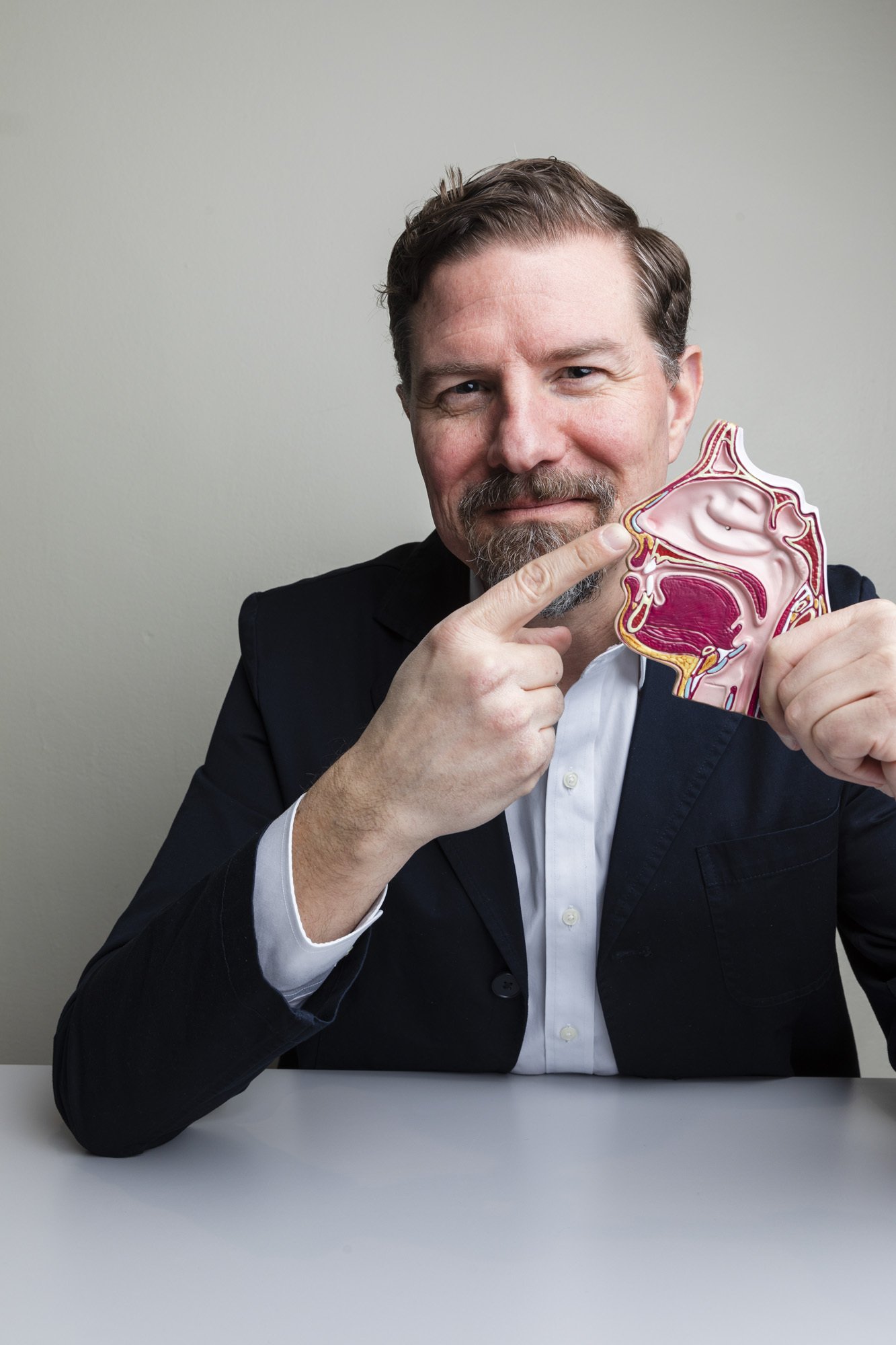 Professor Johan Lundström holding an anatomical model of a nose.
