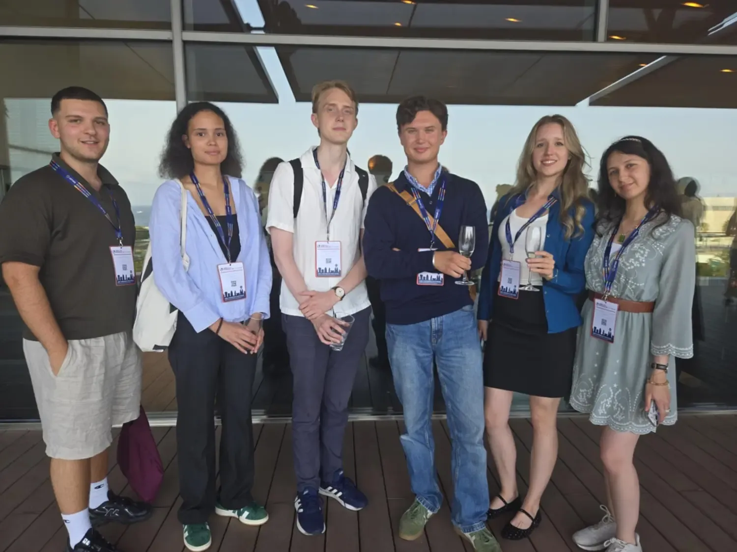 Six students standing next to each other in a group photo.