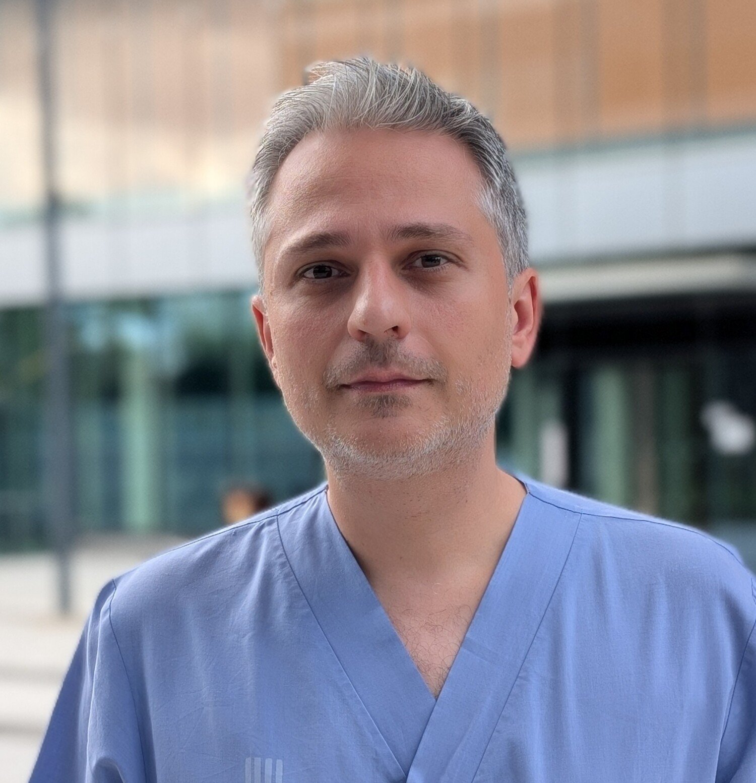 Portrait of Alexios Matikas in blie scrubs
