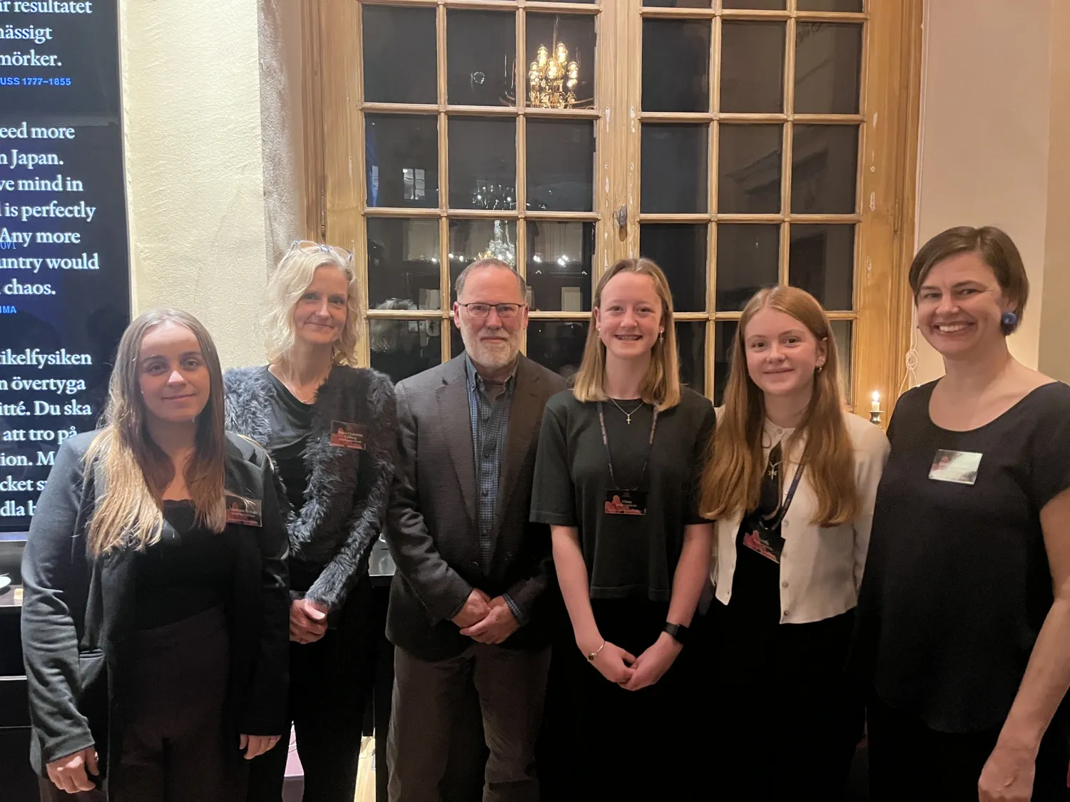Group photo of six people lined up and smiling at the camera.