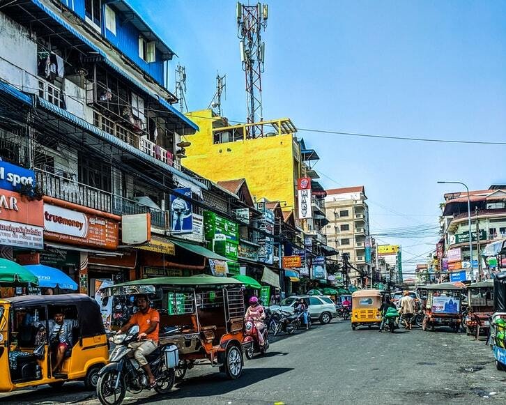 A busy street with cars and mopeds in Phnom Penh, Cambodia