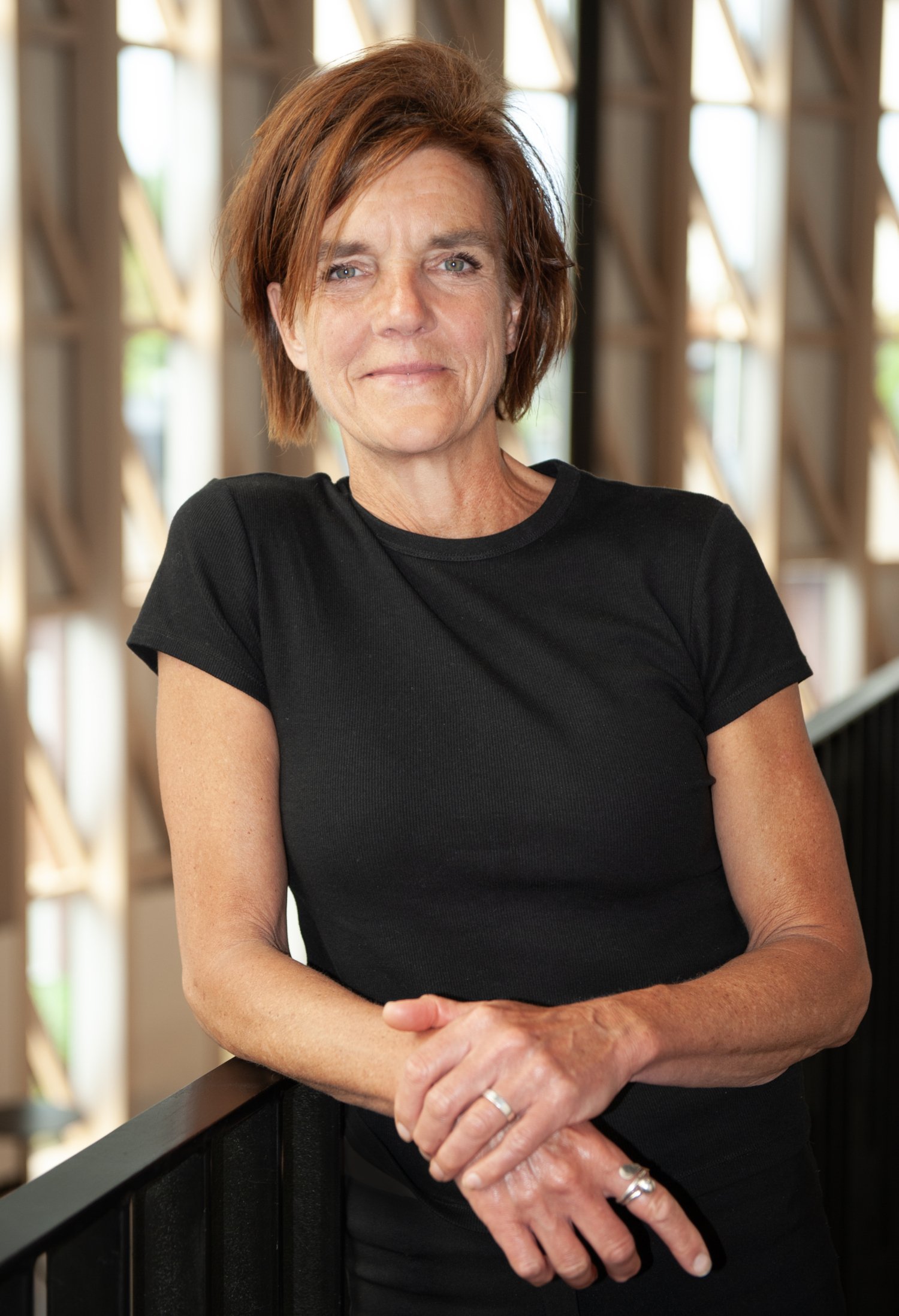 Portrait of a white woman with brown short hair and black t-shirt.