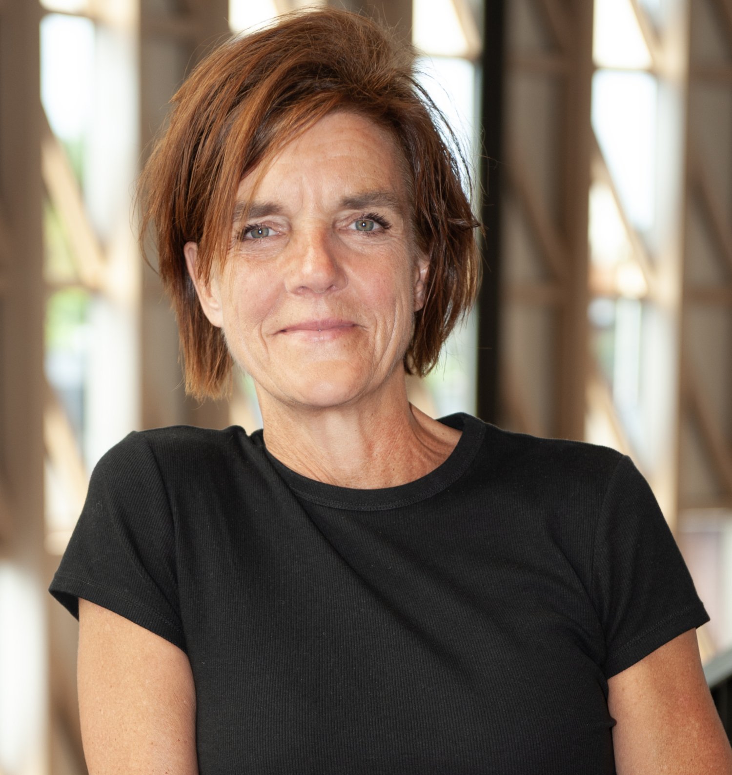 Portrait of a white woman with brown short hair and black t-shirt.