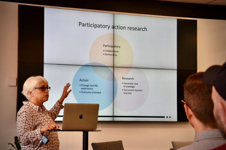 Carol Tishelman presenting her research at the RMIT Health Transformation Lab, presenting a slide entitled "Participatory Action Research"