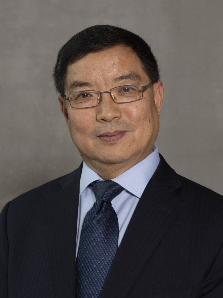 Portrait of Chengxuan Qiu, Aging Research Center (ARC), in suit, againt neutral background.