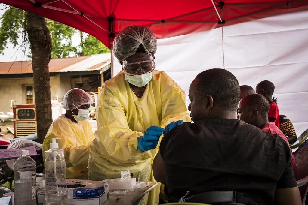 A health worker vaccinates a man in the province North Kivu in DRC.