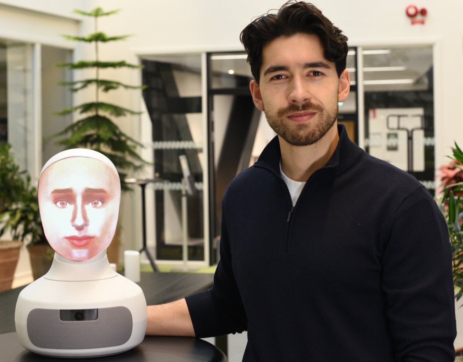 Alexander Borg, doctoral student at the Department of Medicine, Solna, next to the AI-driven robot patient used in teaching at KI.