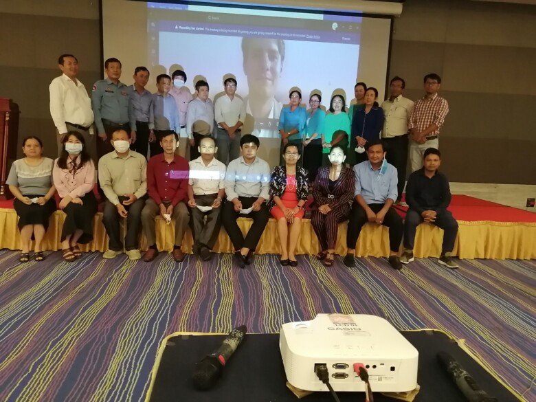 Daniel Helldén is on a screen behind his Cambodian colleagues.