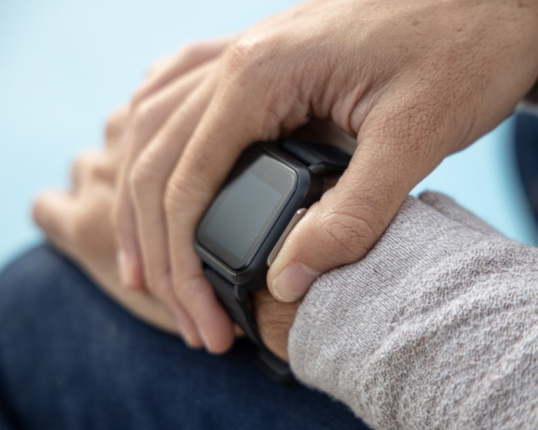 A hand holding a smartwatch