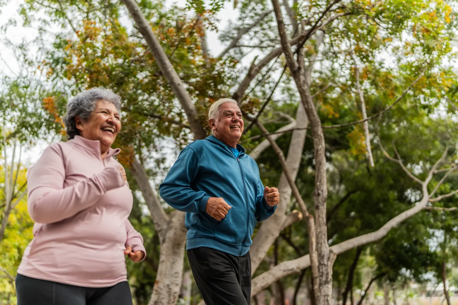 Senior couple talking and running on public park