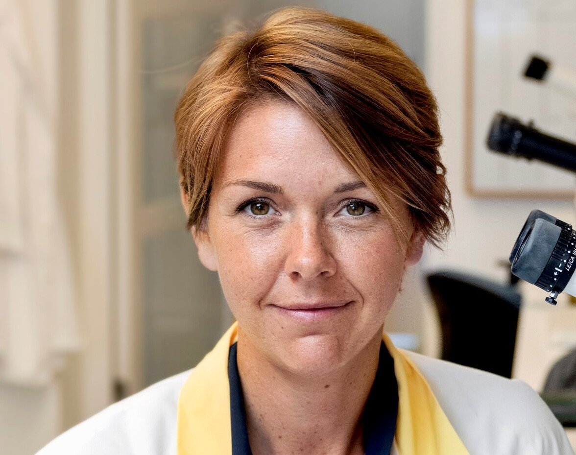 Portrait of a woman in a lab coat.