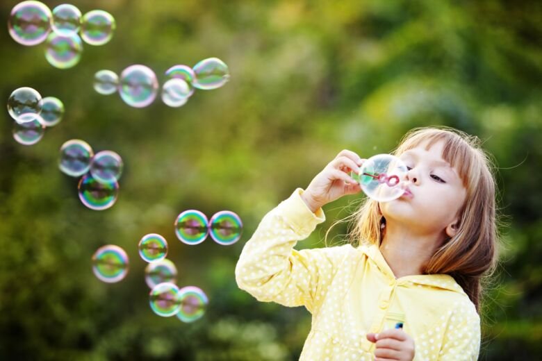 Child playig with soap bubbles
