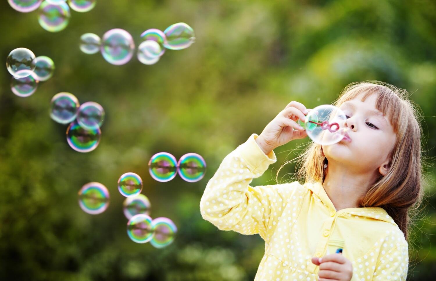 Child playig with soap bubbles