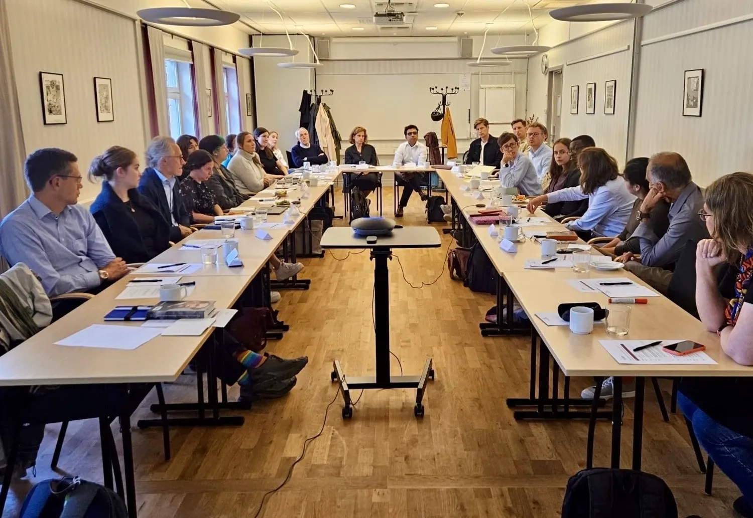 A group of people sitting around a table discussing.
