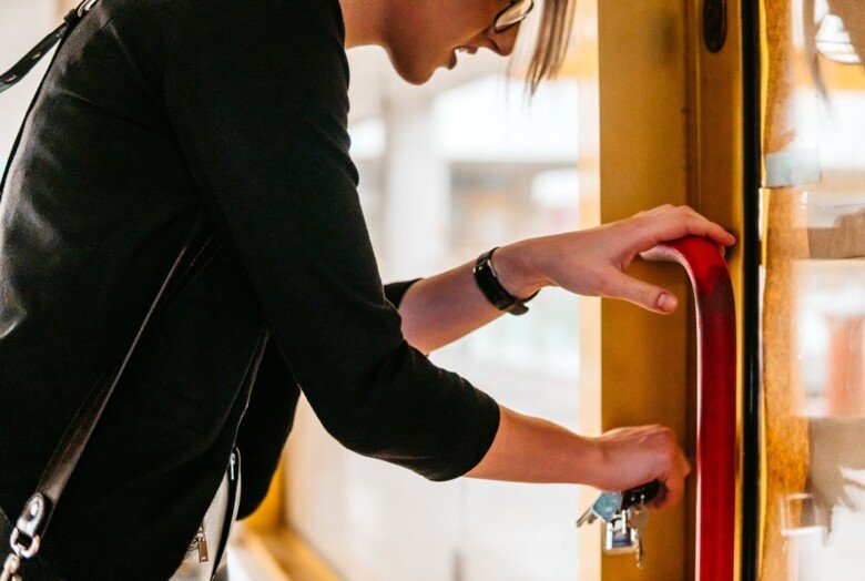 a woman opening the door with a key