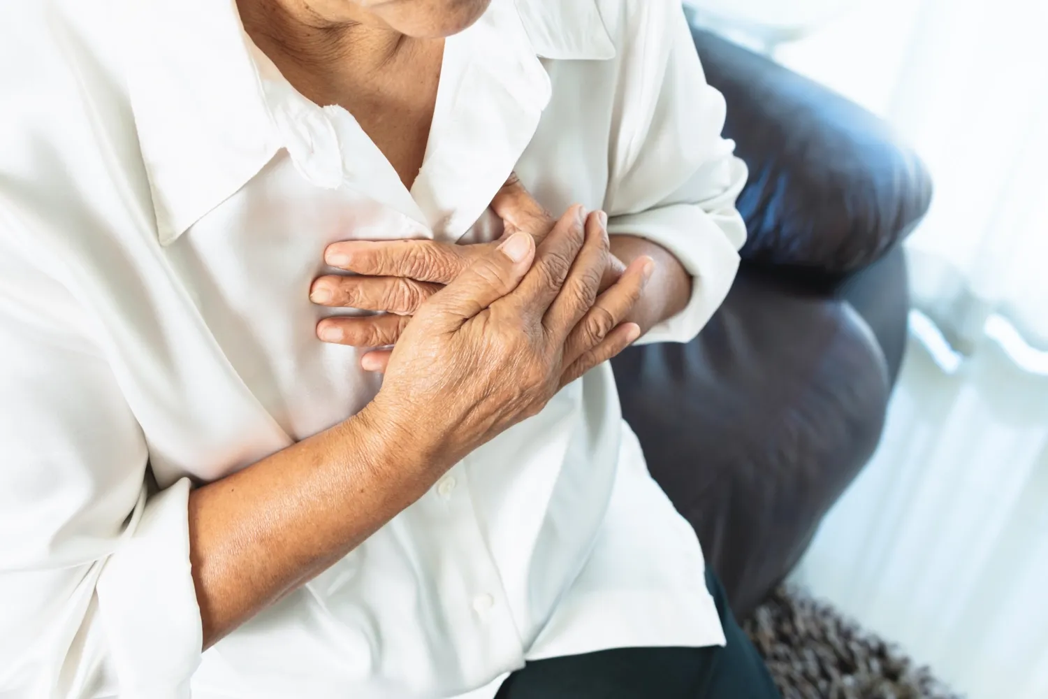 a woman holding chest at her heart
