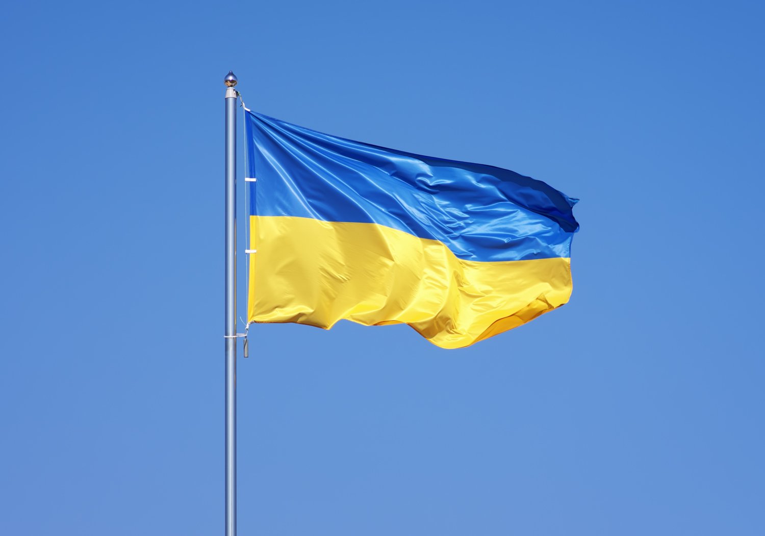 Ukraine's flag against a blue sky.