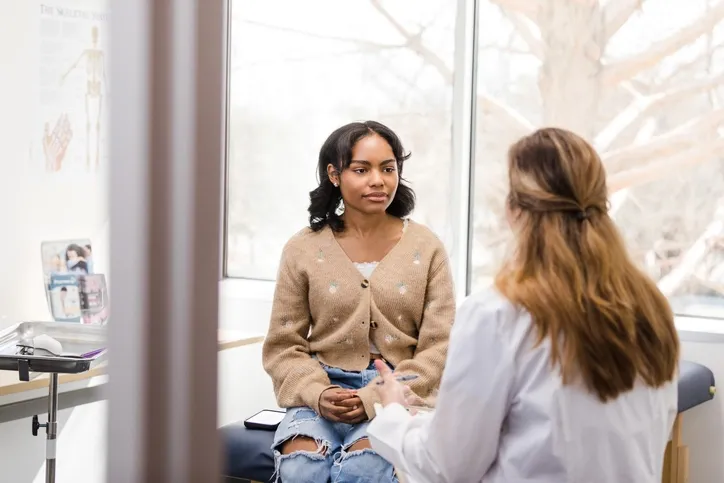 teenage girl talking to healthcare staff