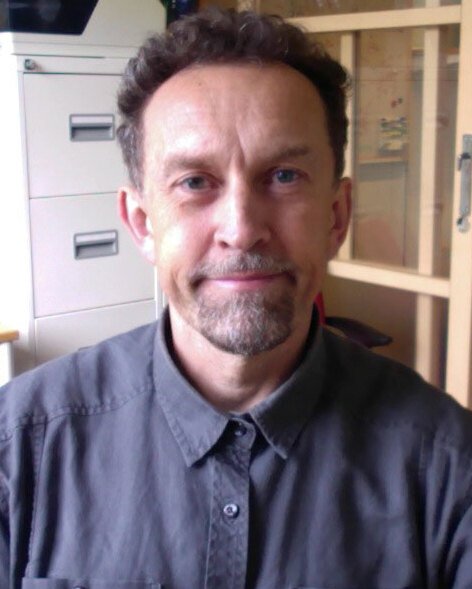 Portrait of Gilberto Fisone, in an office, smiling at the camera