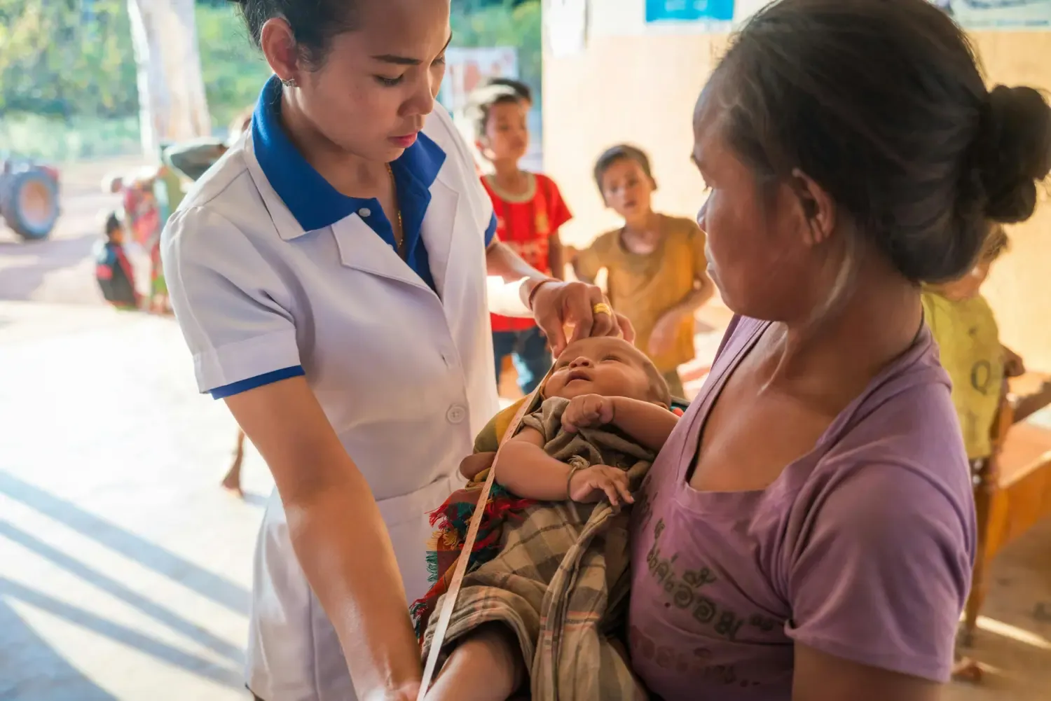 Newborn child being measured.