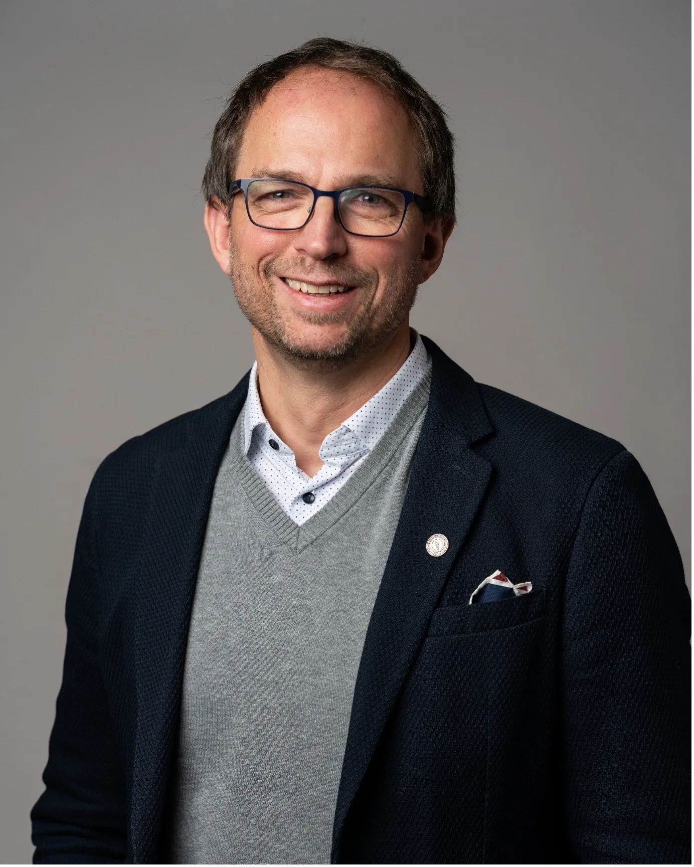 a man in glasses and a suit