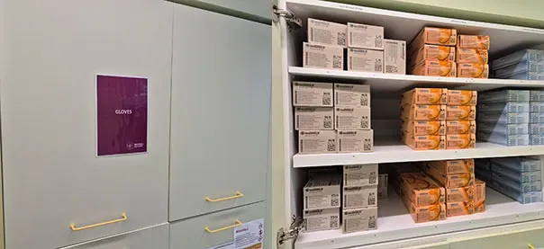 A photo of a storage cupboard with stacks of plastic gloves piled high.