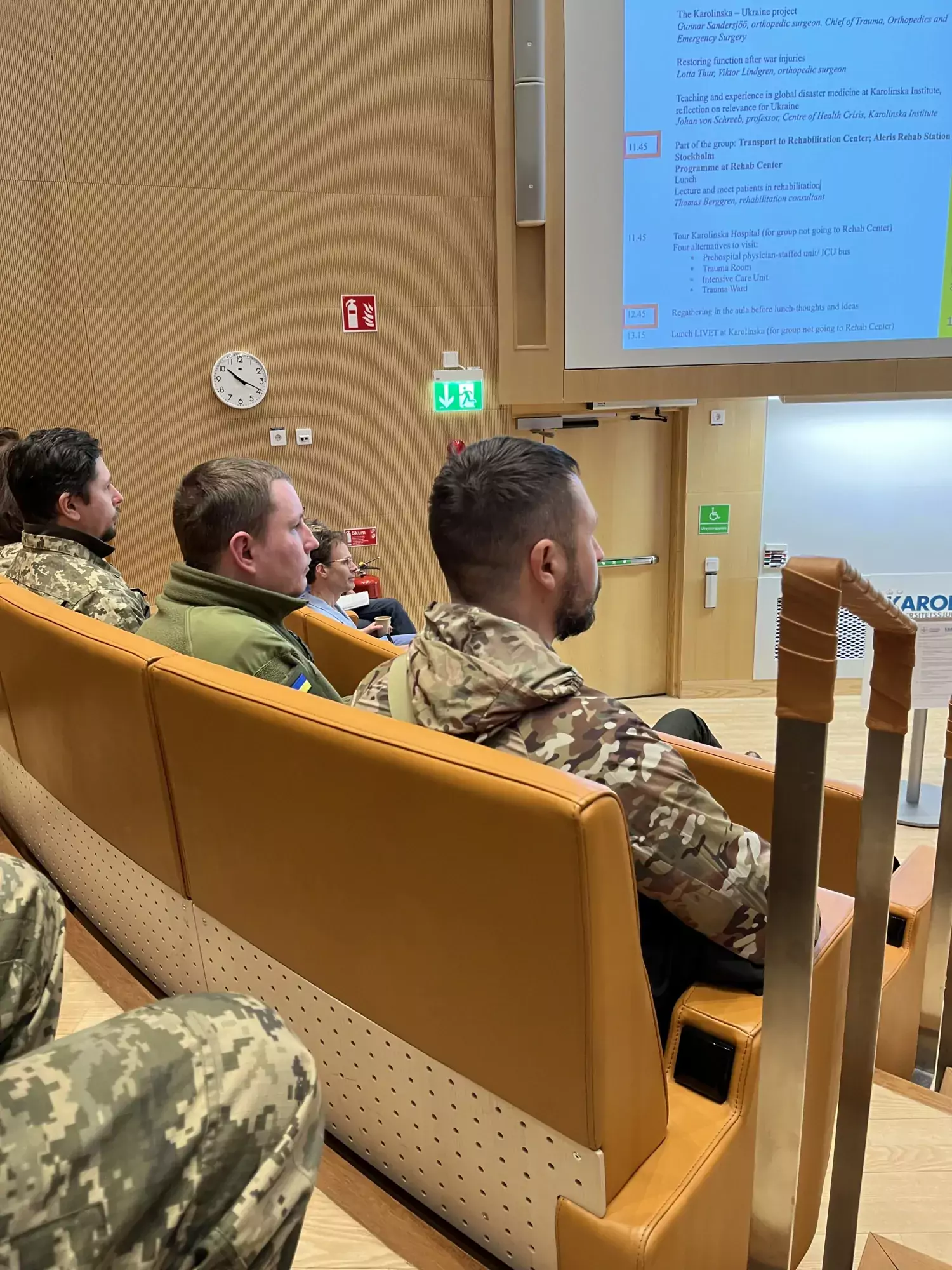 Soldiers in uniform sitting in a lecture theatre