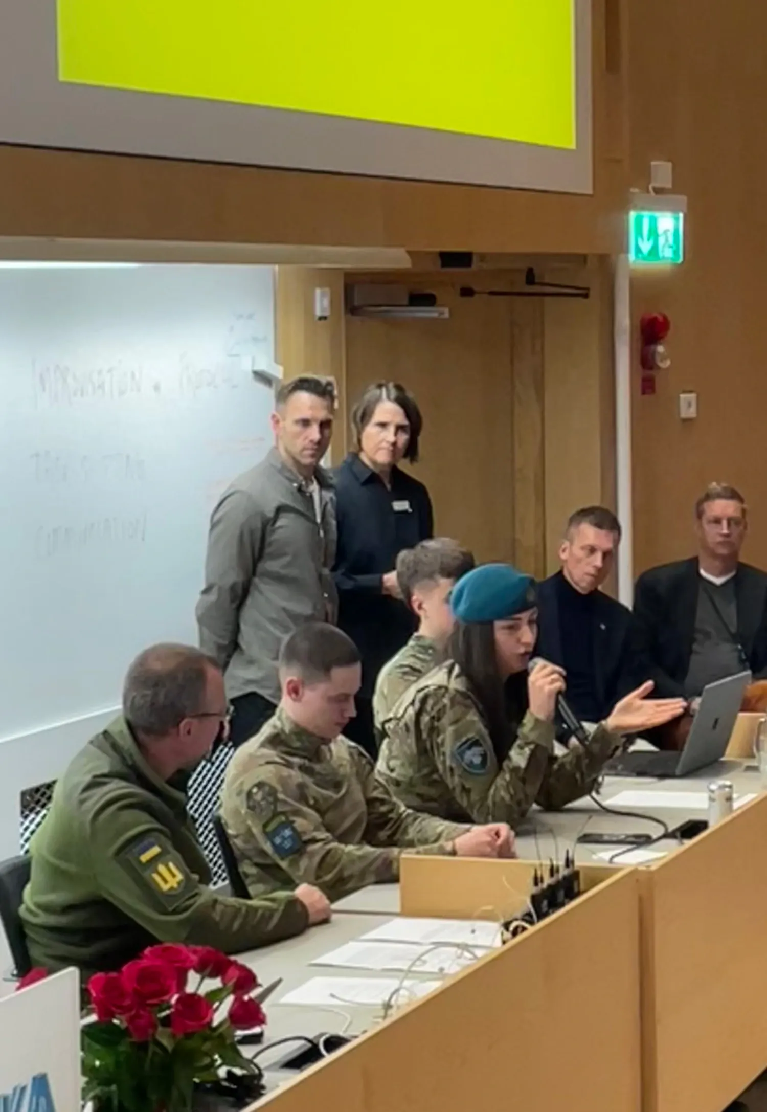 Ukrainian combat medics in a panel discussion in a large conference hall.