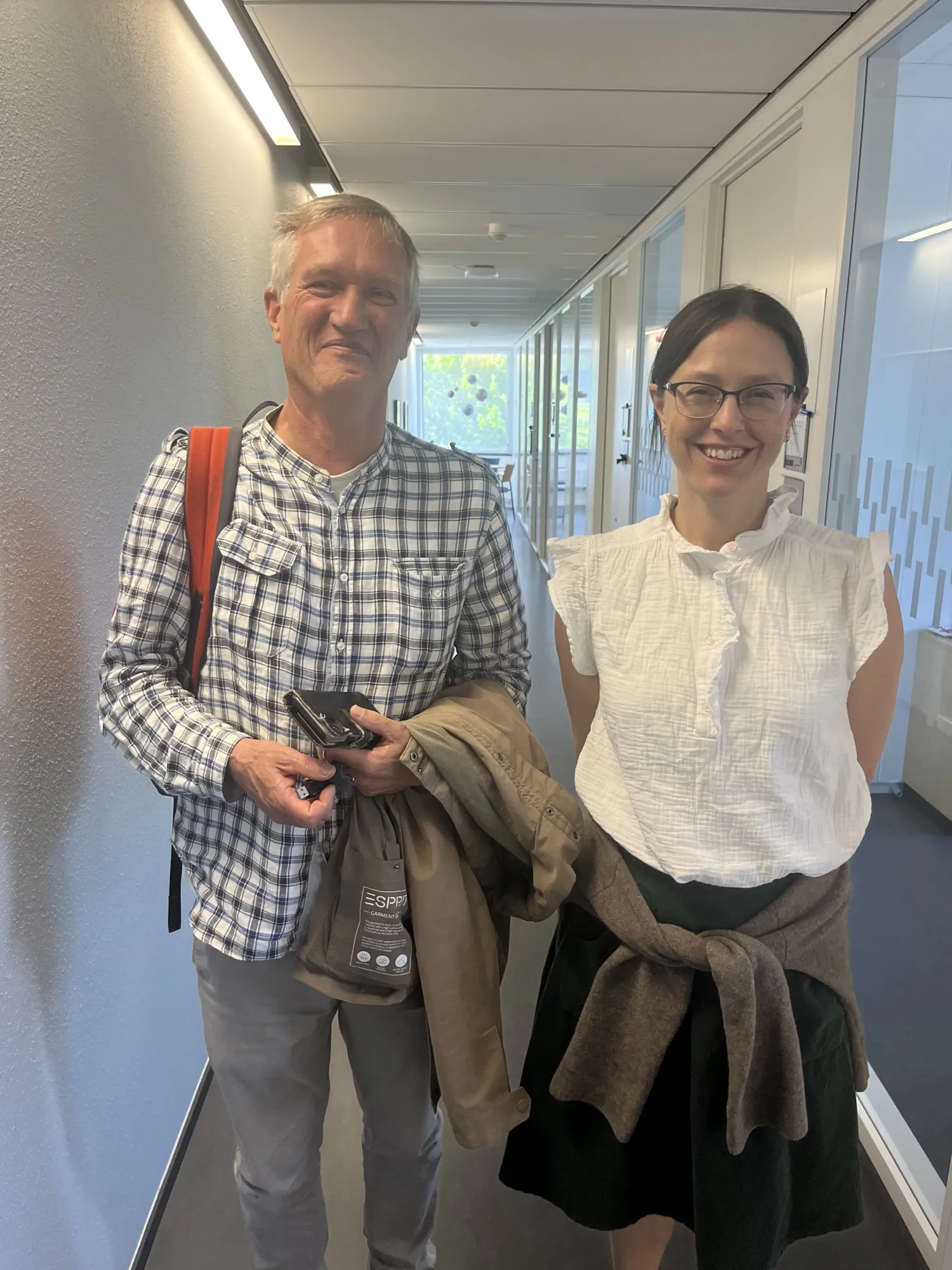 a woman with glasses next to an older man