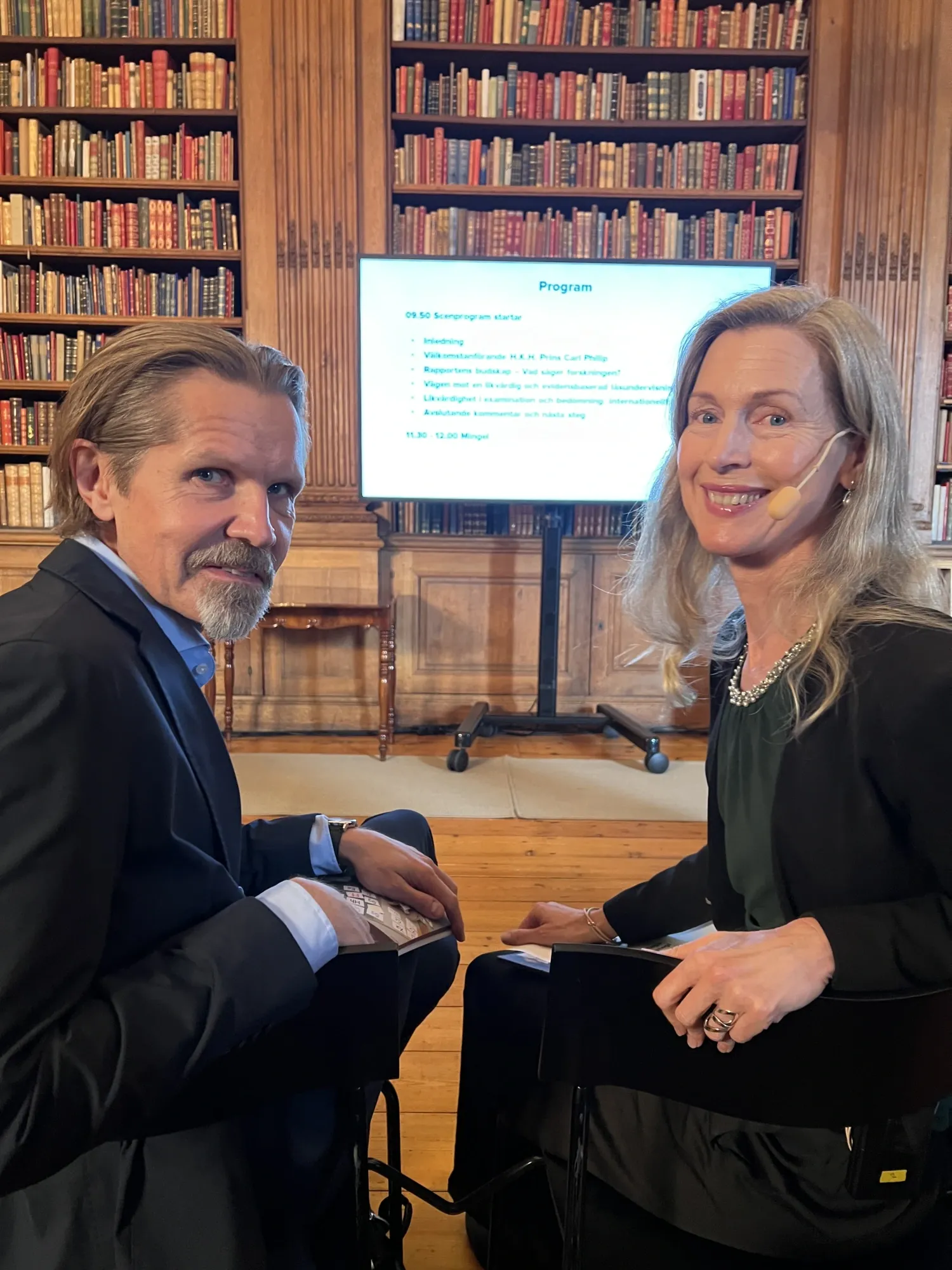 A man and a woman in a library.