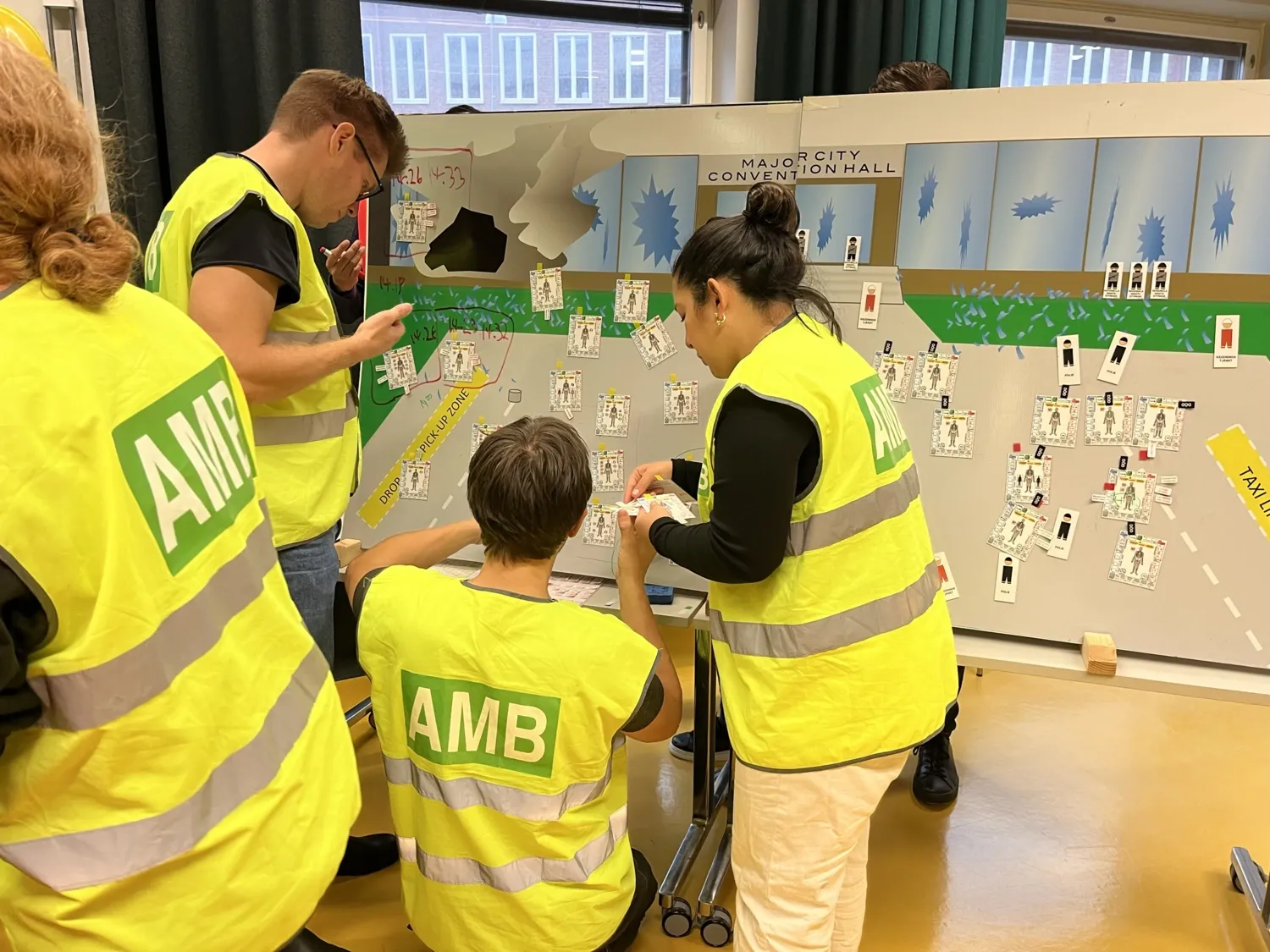 A group of people in high vis vests standing infront of a whiteboard