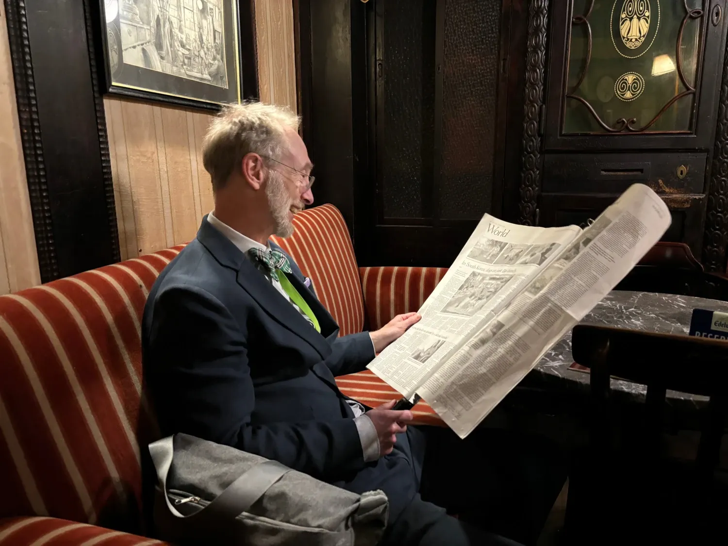 Jonas F Ludvigsson reading a newspaper in a café