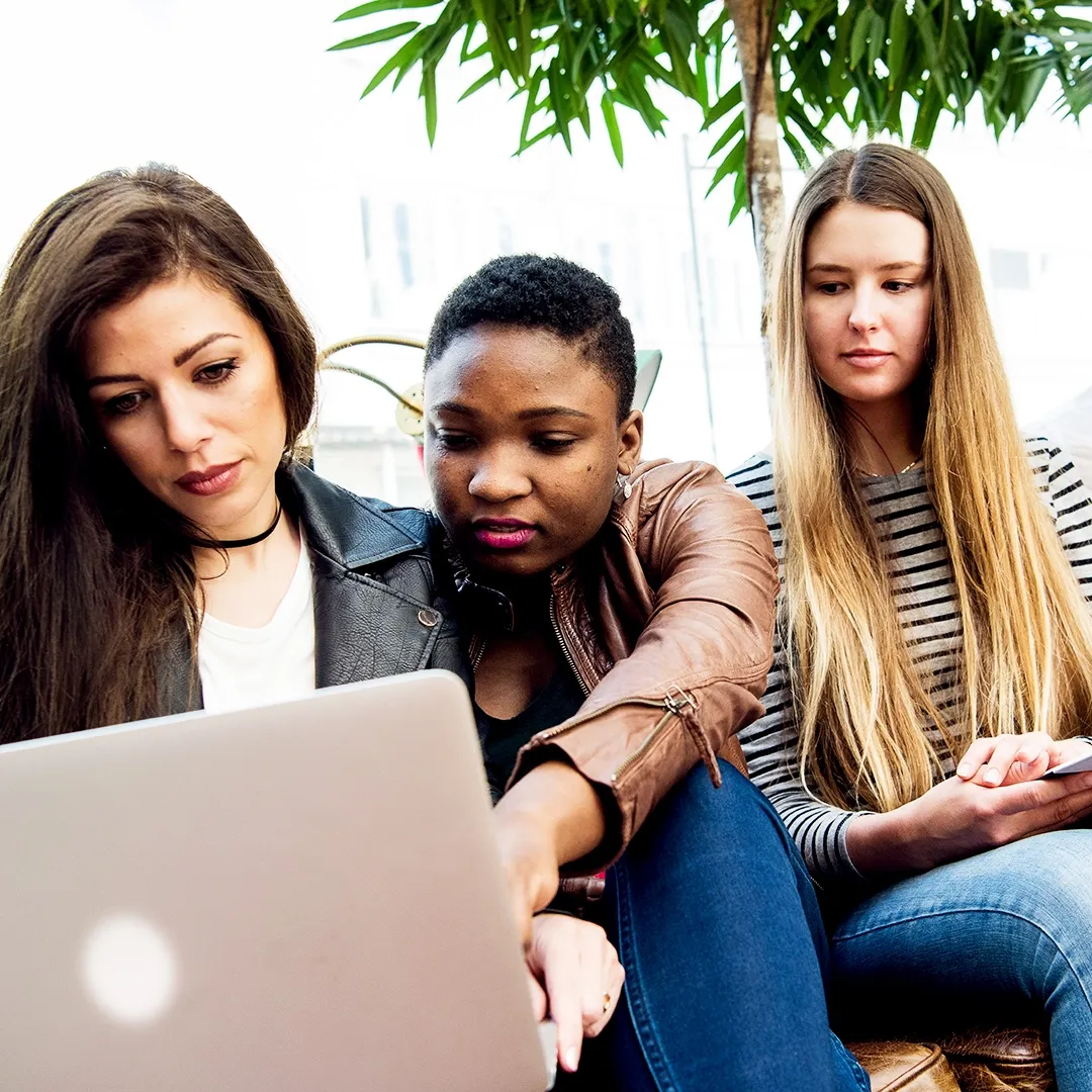 Students looking at laptop