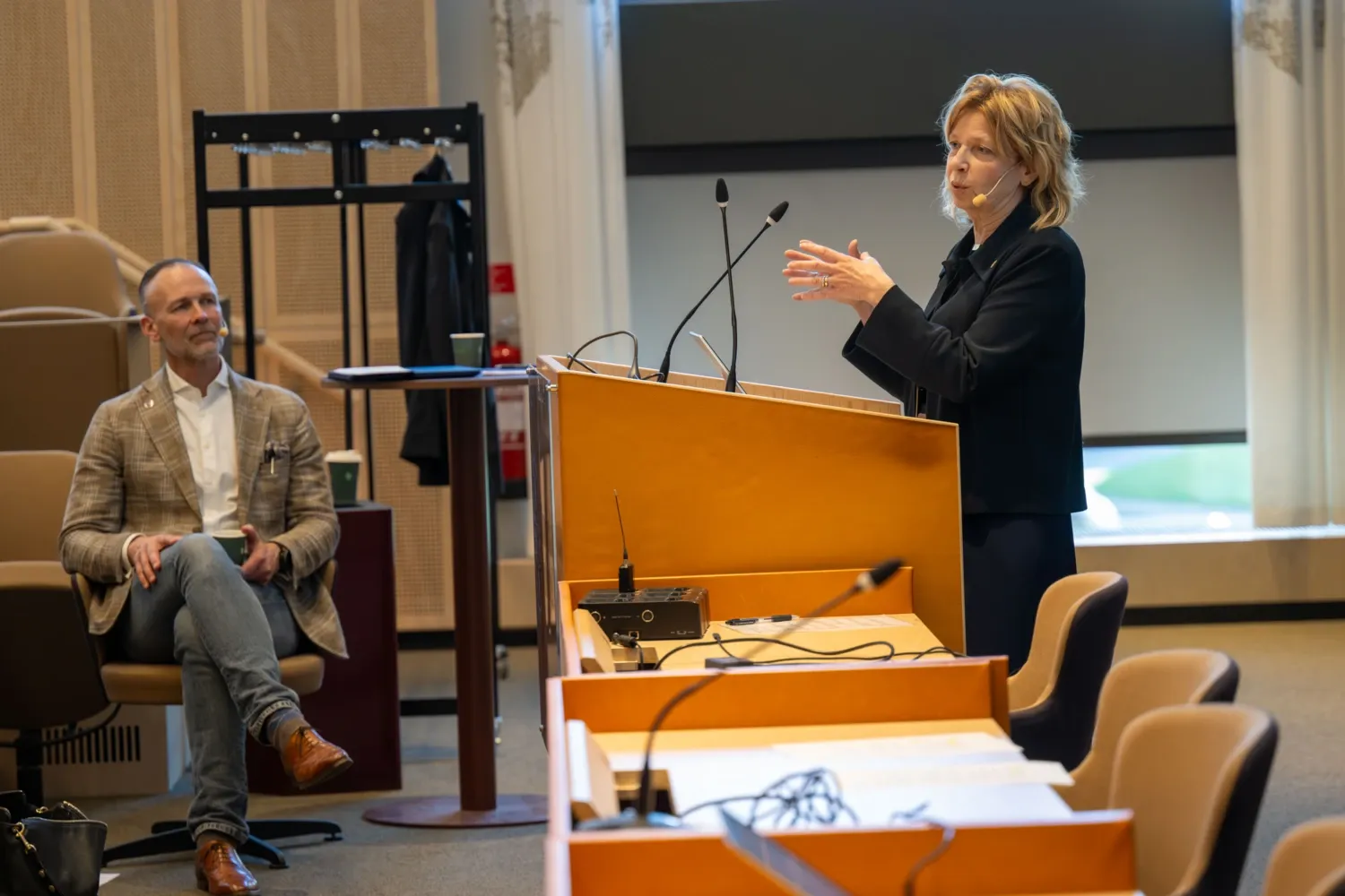 President Annika Östman Wernerson at the podium in a spacious hall at Biomedicum