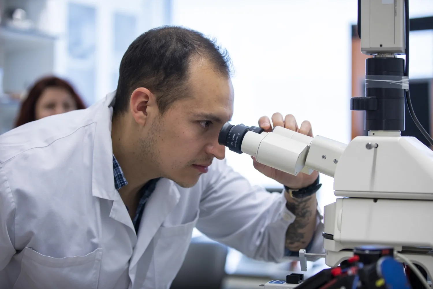 Man looking in to a microscope.