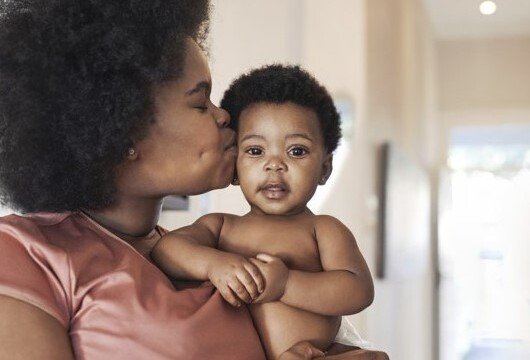 Women holds a child on her arm