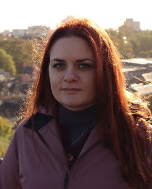 Person in the foreground with a city view in the background.