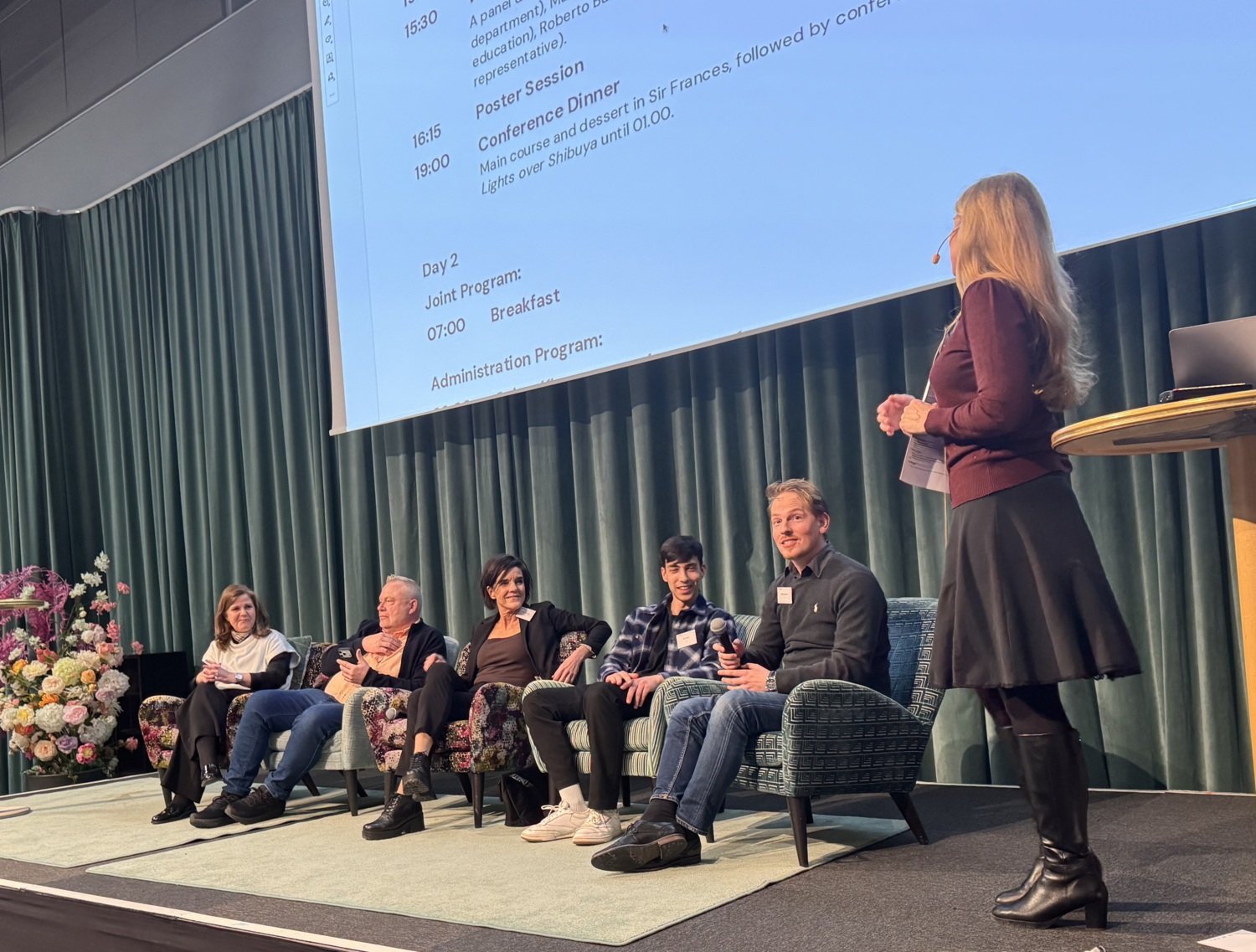 Panel of people sitting in chairs.