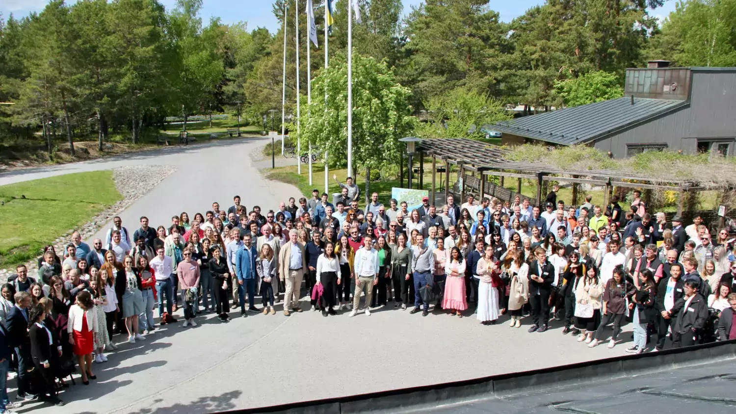 Group photo of attendees standing outside in a half circle.
