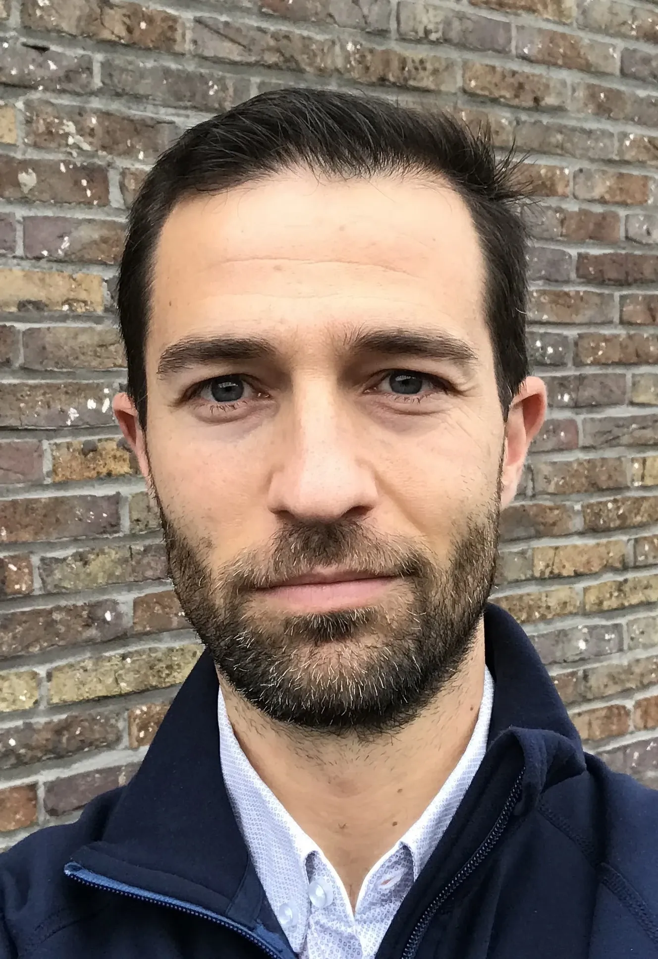 Rodrigo Fernandez Gonzalo in front of a brick wall.