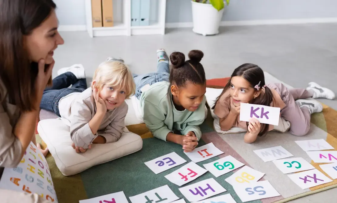 Children and teacher and letters.