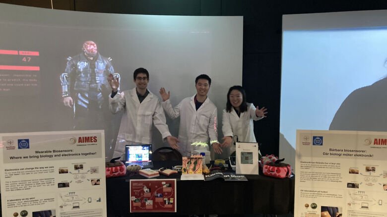 Nicolas Maino, Sihui Xu, Liu Yang in a booth.