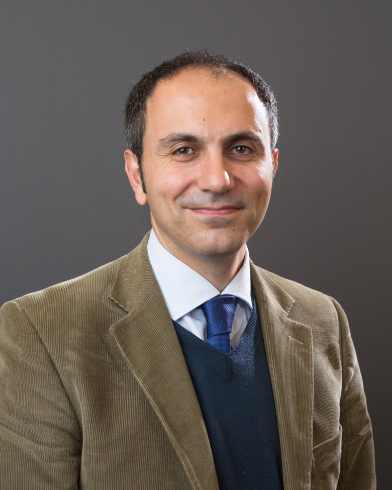 Portrait of Ziad El-Khatib in beige jacket.