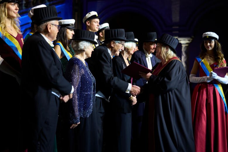 Marie Arsenian Henriksson presents diplomas to 13 jubilee doctors.