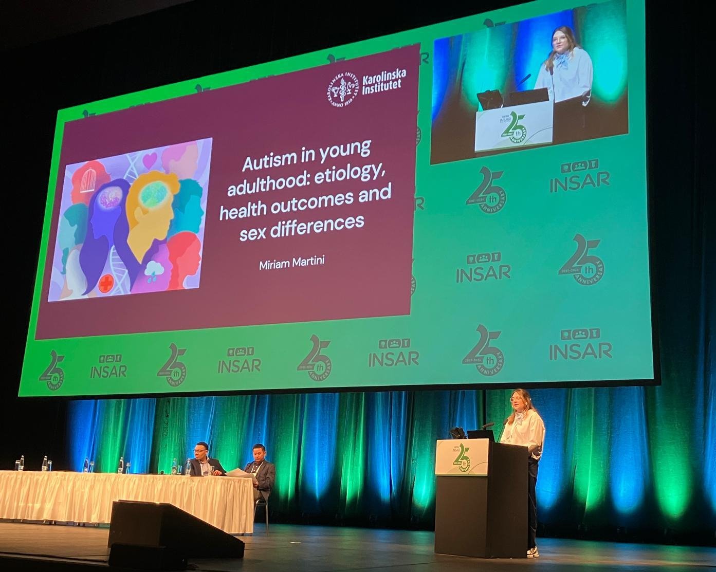 Woman presenting on a stage.