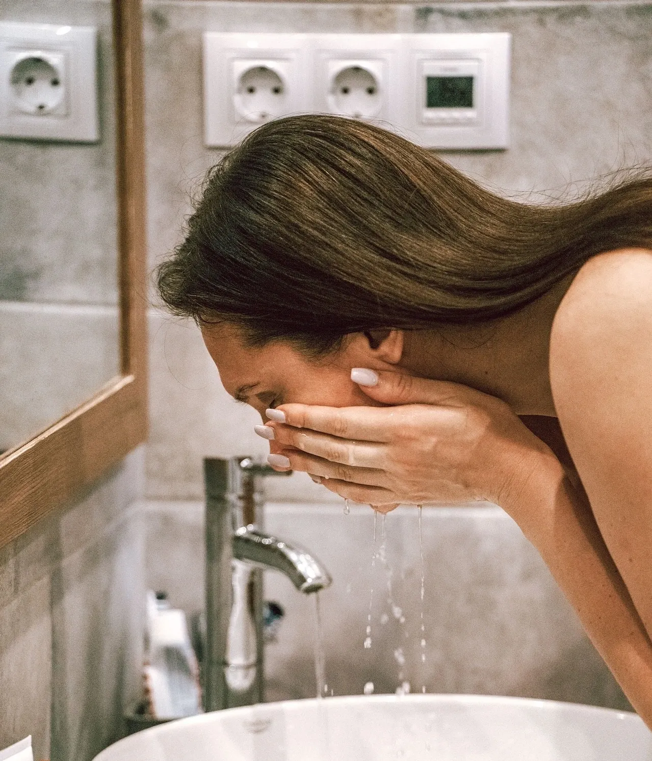 A woman who is washing her face