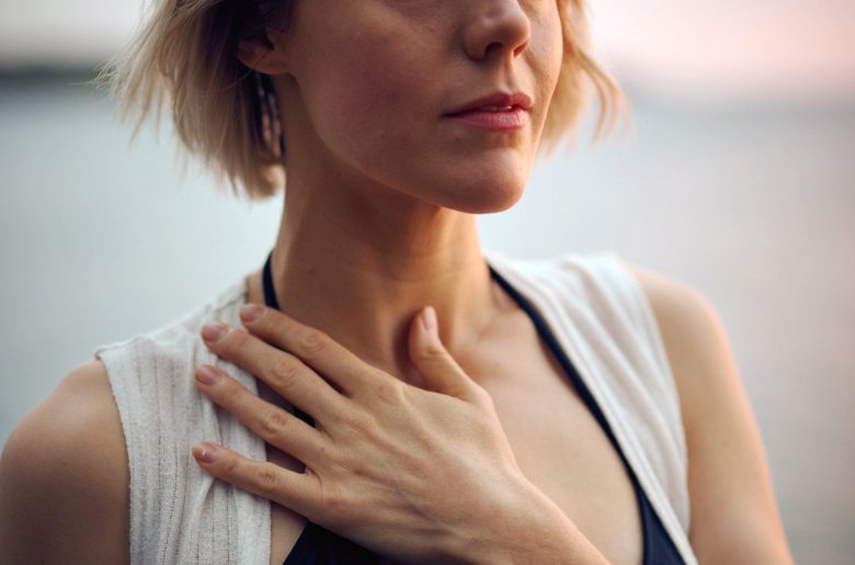 Woman holding a hand on her neck